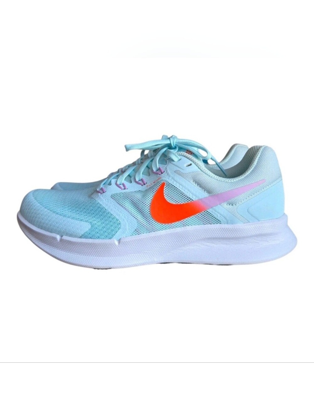 Nike Women's Light Blue Running Shoes with Orange Swoosh